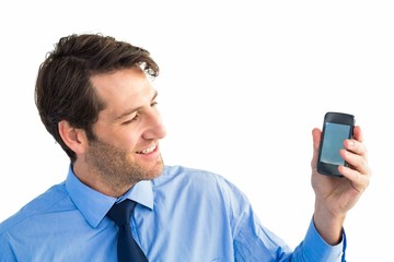 Poster - Smiling businessman showing smartphone to camera