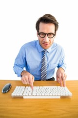 Poster - Businessman typing on his keyboard wearing glasses
