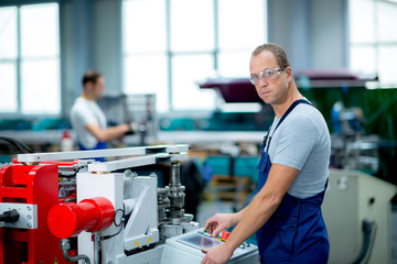 Wall Mural - young worker in factory using machine