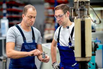 two worker in factory on the machine