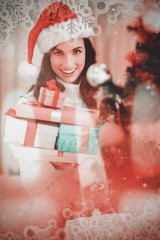 Poster - Brunette holding pile of gifts near a christmas tree