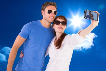 Aufkleber - Composite image of couple using camera for picture