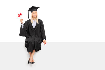 Wall Mural - Female graduate student holding a diploma