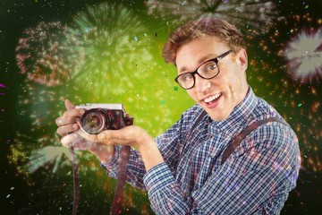 Poster - Composite image of geeky hipster holding a retro camera