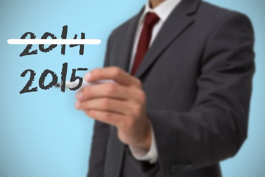 Composite image of classy businessman holding a marker