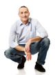 © Piotr Marcinski - Happy handsome mature man squatting