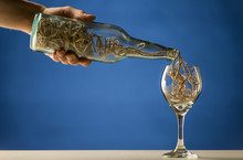 Man Pouring String Into A Wineglass