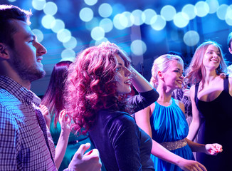 Canvas Print - smiling friends dancing in club