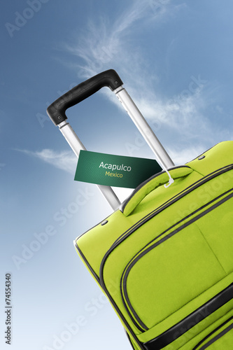 Fotografija Acapulco, Mexico. Green suitcase with label