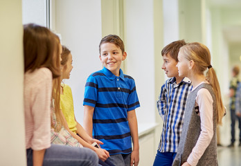 Poster - group of smiling school kids talking in corridor