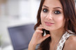 © lenets_tan - Attractive businesswoman sitting  on desk in the office