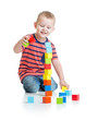 © Andrey Kuzmin - Kid playing and building high tower with colorful blocks