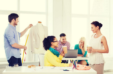 Canvas Print - smiling fashion designers working in office