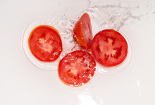 Tomato In Water On White Background