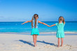 © travnikovstudio - Back view of little girls enjoying summer beach vacation