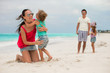 © travnikovstudio - Family of four with two kids during beach summer vacation