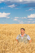 © Ryzhkov Oleksandr - farmer standing in a wheat field