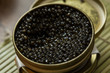 Black caviar in small round metal tin