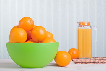 Sticker - orange juice beside delicious ripe oranges on the table