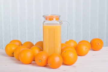 Sticker - orange juice beside delicious ripe oranges on the table