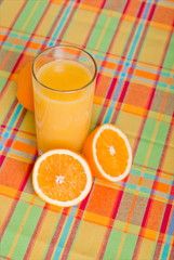 Sticker - Orange fresh juice beside delicious ripe oranges on the table