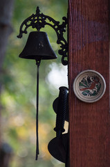 brass bell and a decorated plate