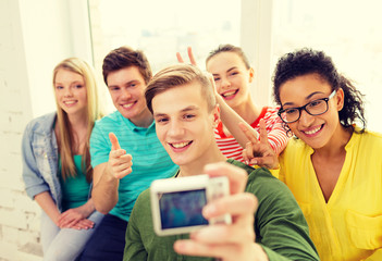 Sticker - five smiling students taking picture with camera