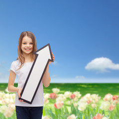 Wall Mural - smiling little girl with blank arrow pointing up