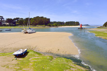 Beach In Low Tide With Boats At Locquirec