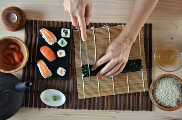 hands cooking sushi