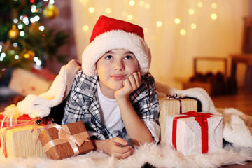 Little boy lying near fireplace in room