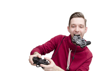 Wall Mural - Young guy playing video game funny holding joystick in his mouth