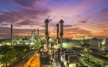 Oil Refinery Plant At Sunset, The Night View Of Petroleum And Petrochemical Factory With Distillation Column, Drum And Pipeline. Gas, Diesel And Chemical Business Industry Is Important For Economy.