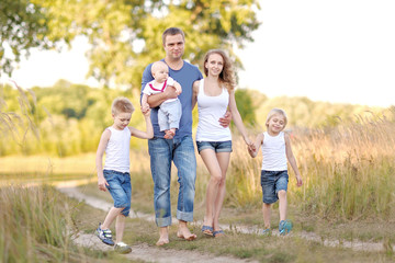 portrait of happy family relaxing in nature summer