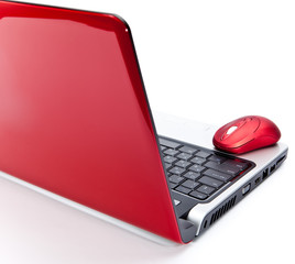 Red computer mouse and red notebook..