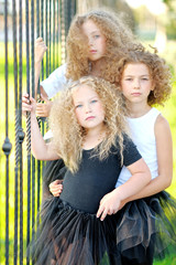 Wall Mural - portrait of a three  beautiful fashion little girls