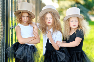 Wall Mural - portrait of a three beautiful fashion little girls