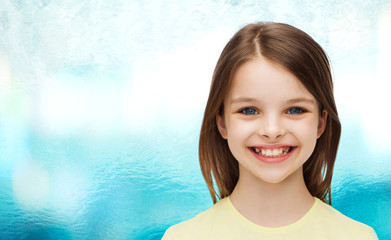 Wall Mural - smiling little girl over white background