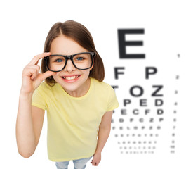 Sticker - smiling little girl in eyeglasses with eye chart