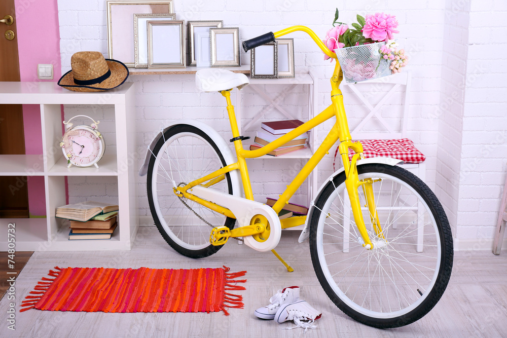 Yellow retro bicycle in spacious bright room