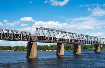 Railroad bridge in Kyiv across the Dnieper with freight train