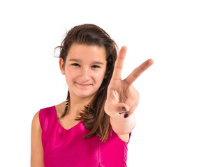 Girl doing victory gesture over white background