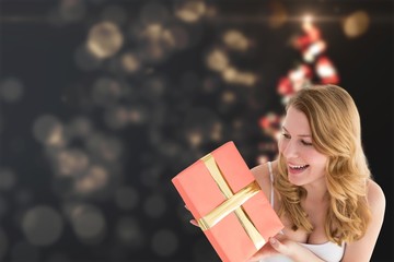 Poster - Composite image of cute blonde holding a gift