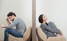 Conflict Between Man And Woman Sitting On Either Side Of A Wall