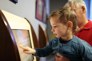Grandfather with grandson using touch screen