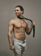 © M-Production - Attractive muscular man posing with tie.