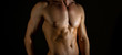 © M-Production - Unrecognizable muscular male body on black background.