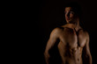 © M-Production - Muscular male model on black background. Place for your text.
