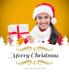 Poster - Composite image of festive brunette holding gift
