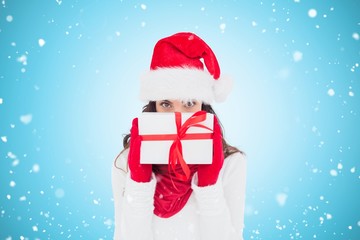 Poster - brunette in red gloves and santa hat showing gift